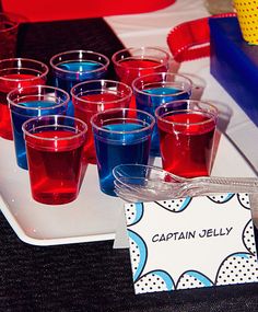 red, white and blue shot glasses on a tray