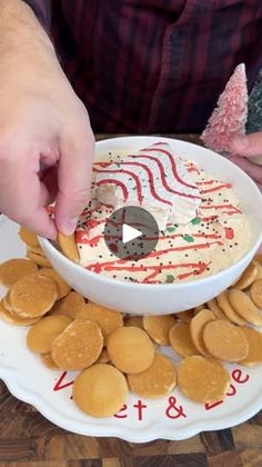 a person dipping some kind of food into a bowl