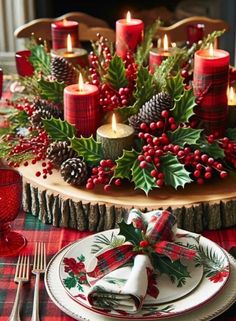 a christmas table setting with candles, holly wreaths and pine cones on the centerpiece