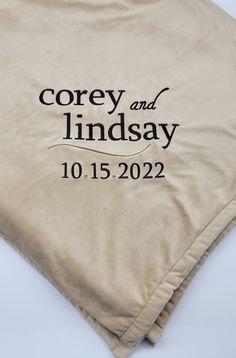 two personalized wedding blankets with the names and date printed on them