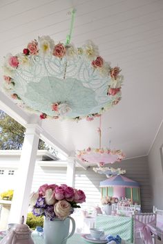 an image of a birthday party with flowers on the ceiling and decorations hanging from the ceiling