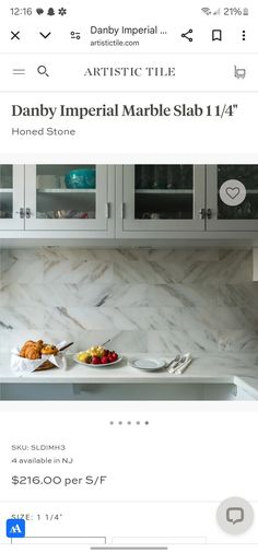 an image of a kitchen with marble countertops and white cupboards on the side