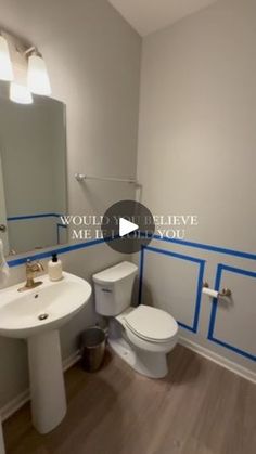 a bathroom with blue tape on the walls