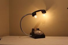 an old - fashioned phone is lit up by a lamp