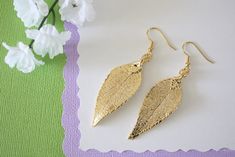 "These are small to medium Real Evergreen Leaf Earrings hand picked, hand painted with Copper Metal and electro-plated with 24kt Gold. Making each leaf unique! These are just gorgeous earrings as the picture doesn't show the true beauty of the leaves. The average leaf earrings drop down 2 1/4 \" from the top of the ear wire x 3/4\" wide CHOOSE A PAIR AT CHECKOUT More earrings at: http://www.etsy.com/shop/lauralidesigns?section_id=5524882 All Leaves come with a paragraph on how it's made and a cu Gold Leaf-shaped Earrings For Gift, Gold Leaf Earrings For Gift, Geode Jewelry, Sterling Silver Cleaner, Real Leaf, Branch Necklace, Gold Leaf Earrings, Tiny Bird, Wedding Store