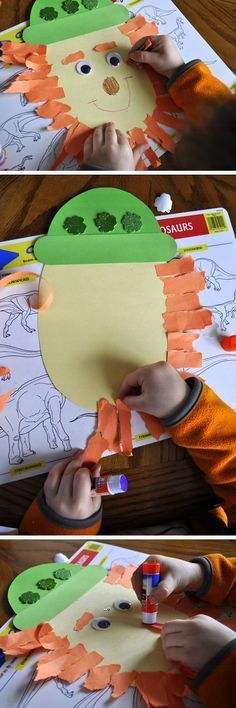 a child is making a dinosaur craft with construction paper