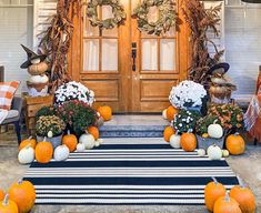 a front porch decorated for fall with pumpkins and flowers