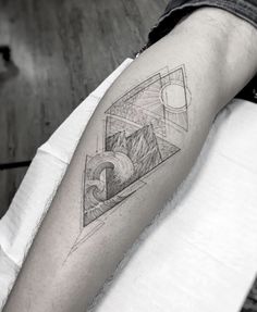 a man's arm with an abstract tattoo design on the left side of his arm