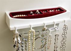 a jewelry rack with several necklaces hanging from it