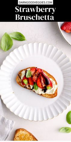 strawberry bruschetta on a white plate with basil leaves