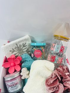 a gift box filled with bath products and personal care items, including a pink flower