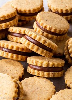 several cookies with chocolate and peanut butter on top are arranged in a pile, ready to be eaten