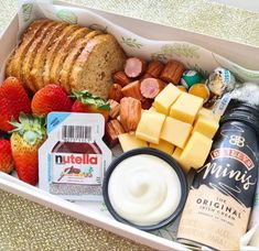 a box filled with bread, cheese, fruit and yogurt