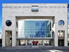 two red heart shaped vases are in front of a building with glass windows and the words pavilion jean - jol desmain pour le musee