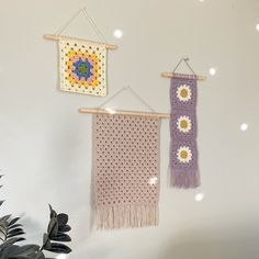 two crocheted wall hangings with flowers on them