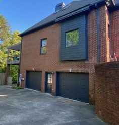 a brick building with two garages on each side