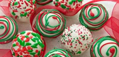 there are many different types of candy on the plate with red and green sprinkles