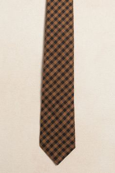 Get ready to impress with our Mens Max Tie in Maple Brown Gingham! Featuring a unique brown and black plaid woven fabric, this self tie style can be easily adjusted for the perfect fit. Add a touch of sophistication to any outfit with this versatile and stylish fall accessory. The perfect look for family matching. Dapper Brown Tie For Business, Classic Brown Neckwear With Ties, Brown Standard Tie For Business, Classic Ties For Fall, Classic Fitted Ties For Fall, Casual Standard Tie For Workwear, Casual Suit And Tie Accessories For Workwear, Brown Standard Tie, Adjustable Brown Suit And Tie Accessories For Business