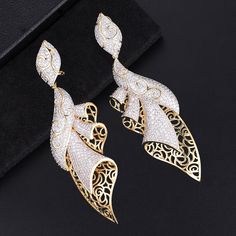 Item Type: Wedding Earrings Gender: Women Material: Cubic Zirconia, Diamond Size: 10.1 x 3.5 cm Earring Type: Drop Weight: 19 g / 0.04 lbs Package Includes: 1 Pair of Earrings Hand Set Cubic Zirconia Evening Earrings, Hand Set Cubic Zirconia Earrings For Evening, Evening Hand Set Cubic Zirconia Earrings, Formal Bridal Earrings With Cubic Zirconia, Formal Cubic Zirconia Bridal Earrings, Glamorous Gold Plated Wedding Earrings, Evening Cubic Zirconia Bridal Earrings, Exquisite Diamond Chandelier Earrings In Gold, Glamorous Gold Plated Earrings For Weddings