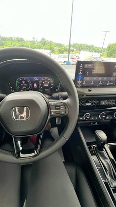 the interior of a car with dashboard and steering wheel