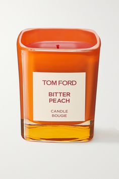 an orange candle with a label on it that says, tom ford bitter peach candles