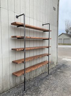 a wooden shelf sitting next to a building