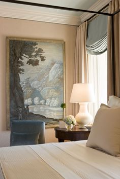 a bedroom with a painting on the wall next to a bed and two nightstands