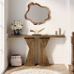 a wooden table with a mirror and vase on it in front of a white wall