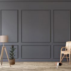 an empty room with two chairs and a lamp on the floor next to a plant