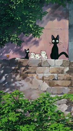 there are many cats sitting on the stone wall