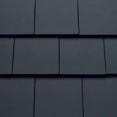 a close up view of the roof of a house with dark gray shingles on it