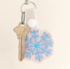 a keychain with a snowflake design on it