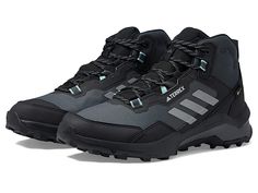 adidas Outdoor Terrex Ax4 Mid GORE-TEX(r) Shoes - Women's Shoes : Black/Grey/Mint Ton : Gather some adoring glances and enjoy exceptional comfort as you hit the hiking trails wearing the adidas Outdoor Terrex Ax4 Mid GORE-TEX Shoes. Mesh and synthetic upper with waterproof GORE-TEX membrane. Breathable man-made lining. Molded cushioned insole for elevated comfort and arch support. Lace-up construction for a secure fit. Dual density EVA midsole for added cushioning comfort. Signature stripes on t Black Shoes Women, Outdoor Woman, Hiking Shoes, Gore Tex, Hiking Trails, Shoes Black, Arch Support, Black Grey, Adidas Women