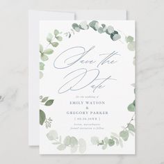 an elegant save the date card with eucalyptus leaves