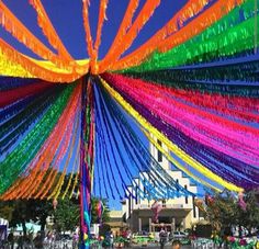 colorful streamers hanging from the ceiling in front of a building