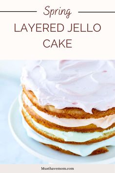 a cake with white frosting and pink icing sitting on top of a plate