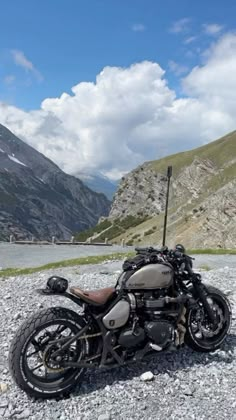 a motorcycle parked on the side of a mountain