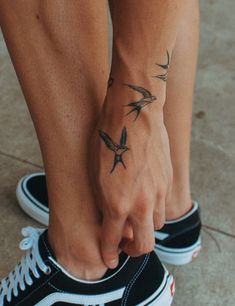 a person with a bird tattoo on their foot