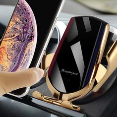 a person holding an iphone in their car with the phone holder attached to the dashboard