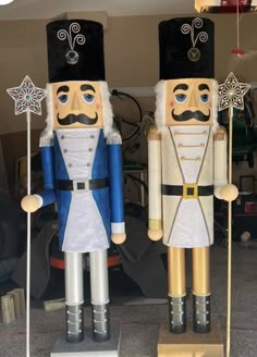 two wooden nutcrackers standing next to each other