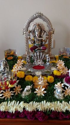 a table topped with lots of different types of flowers and silver items on top of it