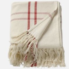 a white and red plaid blanket with fringes