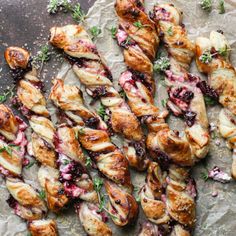 croissants with blueberry sauce and herbs on top