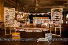 the table is set up for a baby's first birthday party with photos and decorations