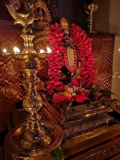 an ornate shrine with candles and flowers on it