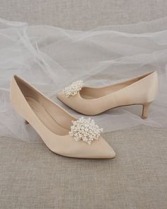 Perfect pointy toe heels with elegant mini pearls brooch is beautiful simplicity. Easy slip on with comfort for bride and wedding party. Detail: FIT: STYLE RUNS SMALL, ORDER HALF SIZE UP FROM YOUR REGULAR SIZE HEEL HEIGHT: 2 InchesCOLORS AVAILABLE: White, Ivory, and ChampagneUPPER: Synthetic upper and liningMATERIALS: Manmade outsole Not sure of which size to purchase? Shoes measurements are as follow:(Please note measurements taken the length of inside of shoe from toe to heel)Size 5.5 - 9.5”Si Bridal Kitten Heels, Women Wedding Shoes, Bridesmaids Shoes, Pearl Shoes, Flower Girl Shoes, Wedding Shoes Bride, Pointy Toe Heels, Bridal Heels, Bridesmaid Shoes