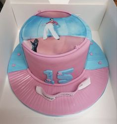 a cake in the shape of a hat with a man on top and stars around it