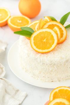 there is a cake with oranges on top and white frosting around the edges