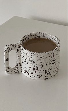 a white and black mug sitting on top of a table