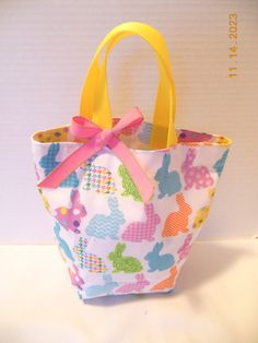 Looking for an Easter basket or gift bag, this little purse/tote will delight any little girl or toddler who likes to be just like Mommy! Perfect for taking along any essentials for a shopping trip, restaurant, off to Grandma's or the beach for the day. Plenty of room for crayons, "make up," a few little toys or whatever she might need - even a pair of pj's would fit. Can also be used as a gift bag or as a party favor. This little bag measures approx. 10 inches wide by 9 inches tall. Fully lined Cute Small Bags For Gifts, Small Cute Bags For Gifts, Cute Pink Lunch Bag For Gift, Cute Bucket Bag For Gift, Cute Multicolor Bags For Gift, Cute Small Gift Bags, Fun Rectangular Bags For Gifts, Handmade Fun Bags For Gifts, Fun Rectangular Bags Ideal For Gifts